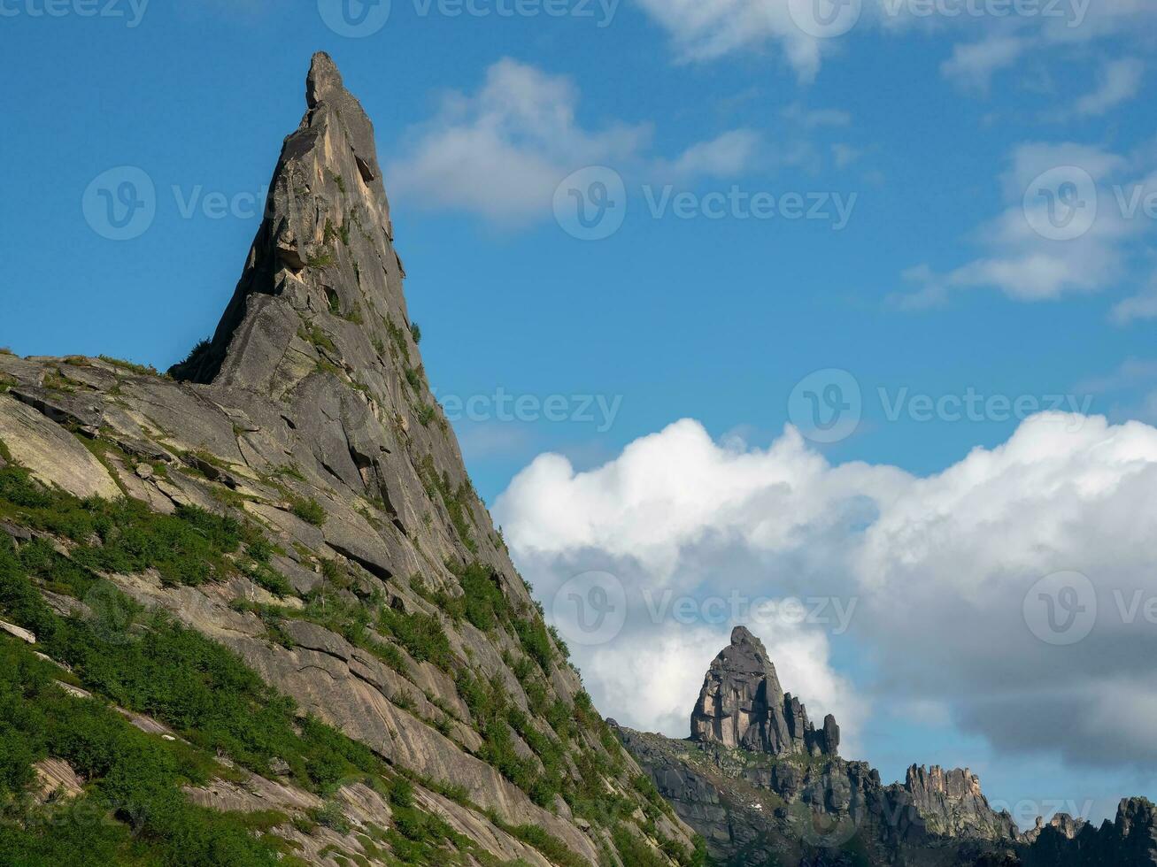 Pointed cliff, a misty mountainside. Ghost rocks. Awesome scenic mountain landscape with big cracked pointed stones closeup in misty morning. Sharp rocks background. Western Sayans photo