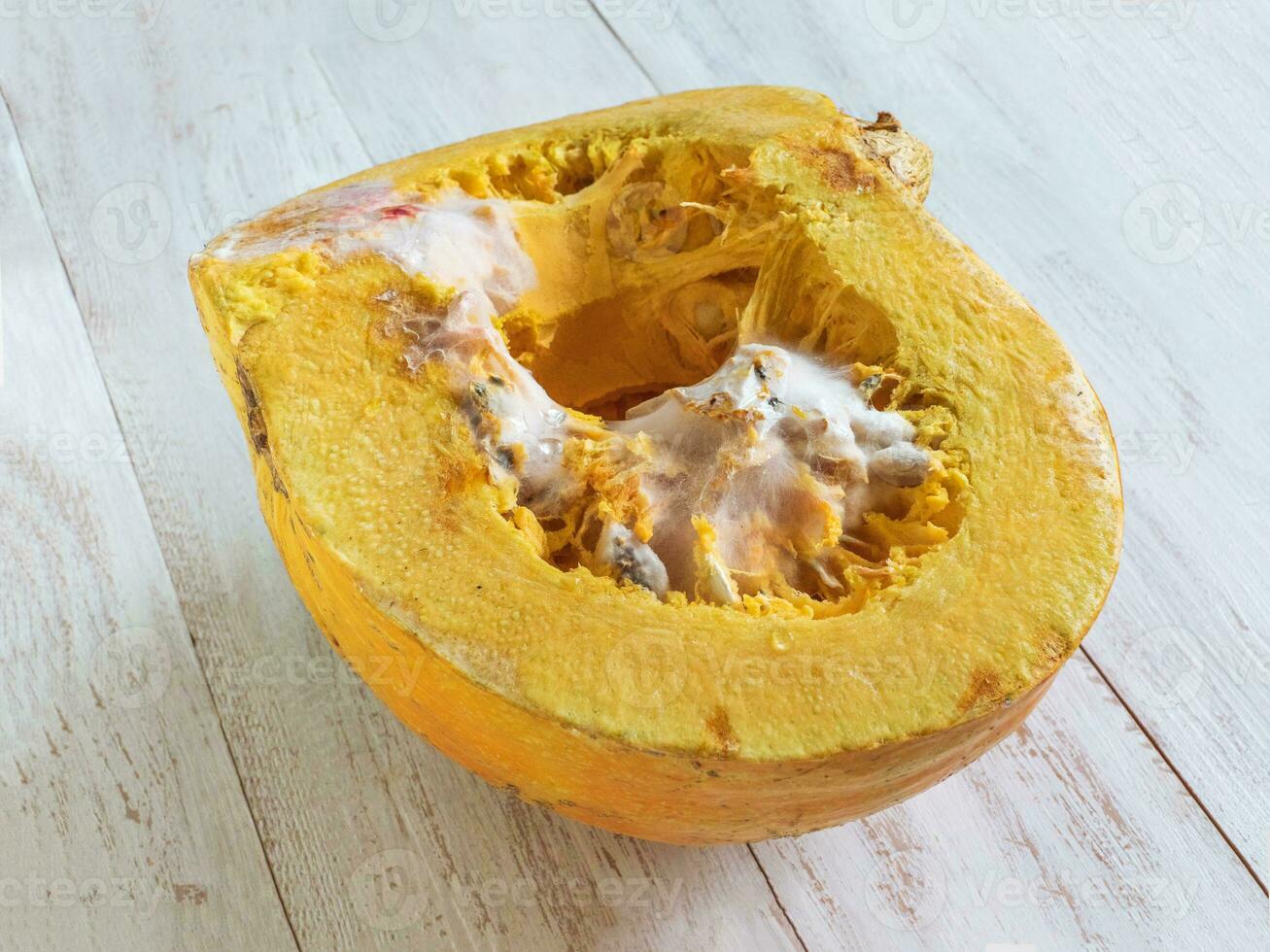 Rotten pumpkin on the table photo