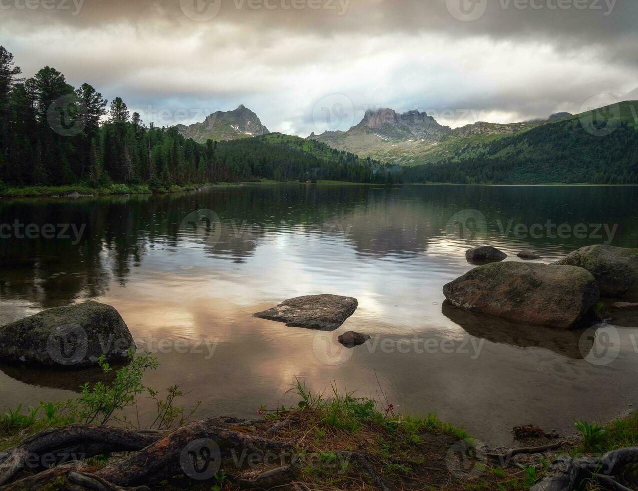 Rain at sunset at a mountain lake. Ergaki Nature Park in the mountains of Siberia. Western Sayan. photo