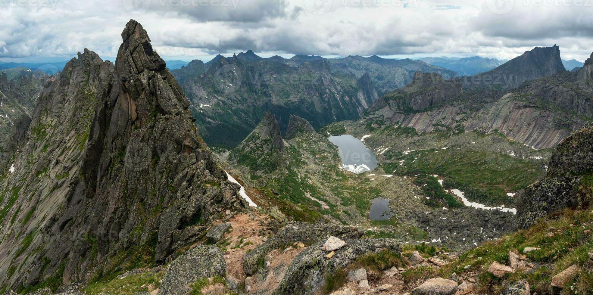 Pointed cliffs mountainside. Ghost rocks. Awesome scenic mountain landscape with big cracked pointed stones in misty rainy morning. Sharp rocks background. Western Sayans, Ergaki. Panoramic view. photo