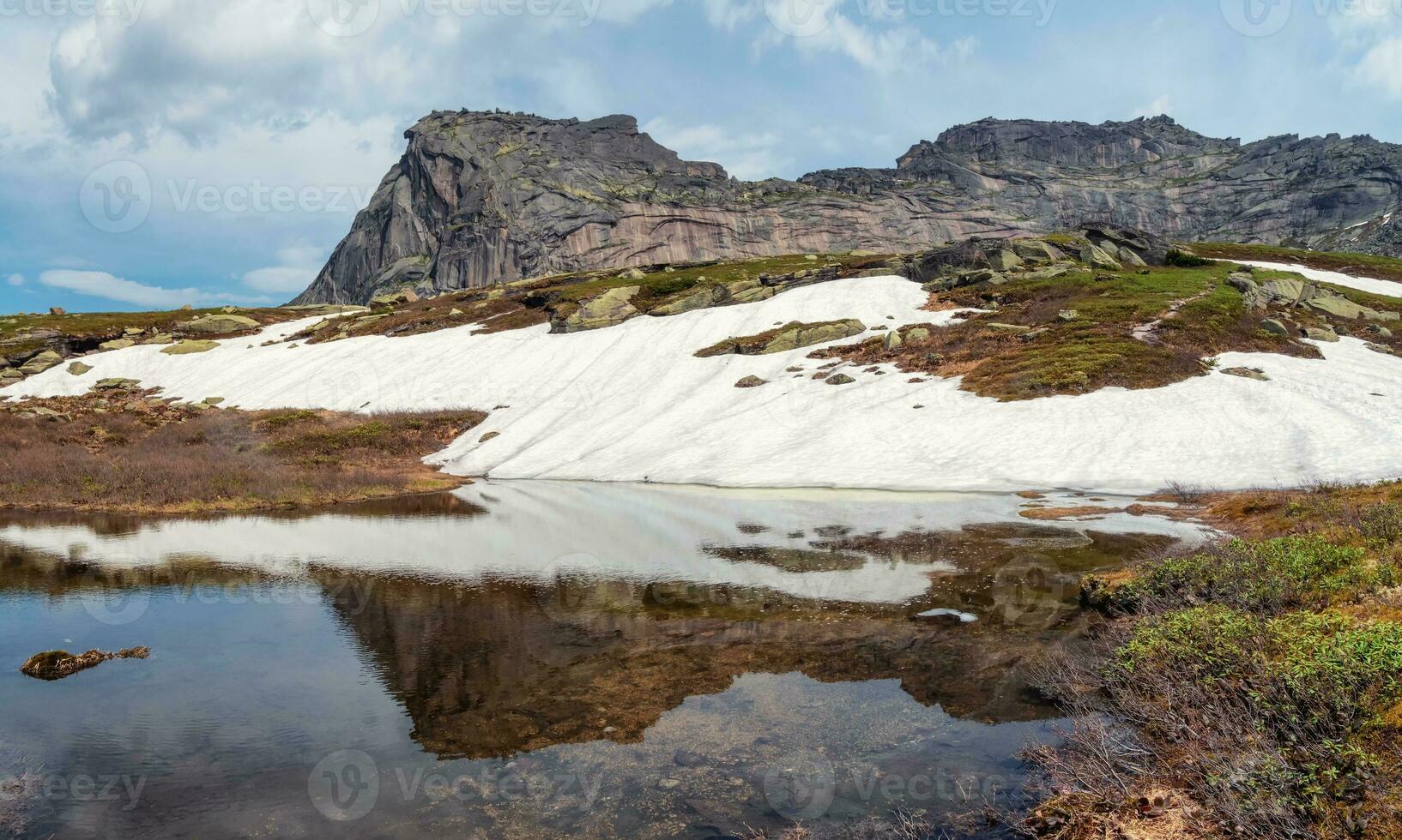 Mountain Sleeping Sayan, Natural Park Ergaki, Russia. A unique mystical mountain is reflected in a glacial lake. Panoramic view. photo
