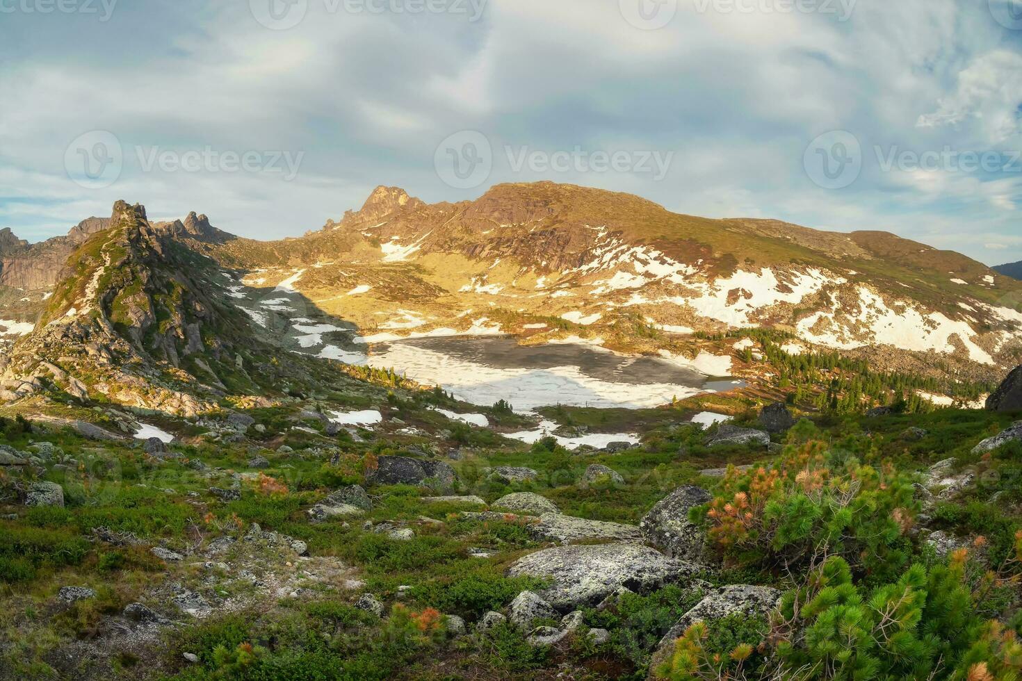 Minimalistic beautiful mountain scenery with golden light on snow slopes mountains. Scenic mountain landscape with illuminating color in blue sky. Western Sayan. photo
