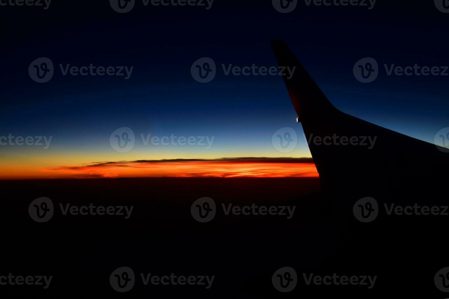 mysterious sunset with clouds from the airplane window with photo