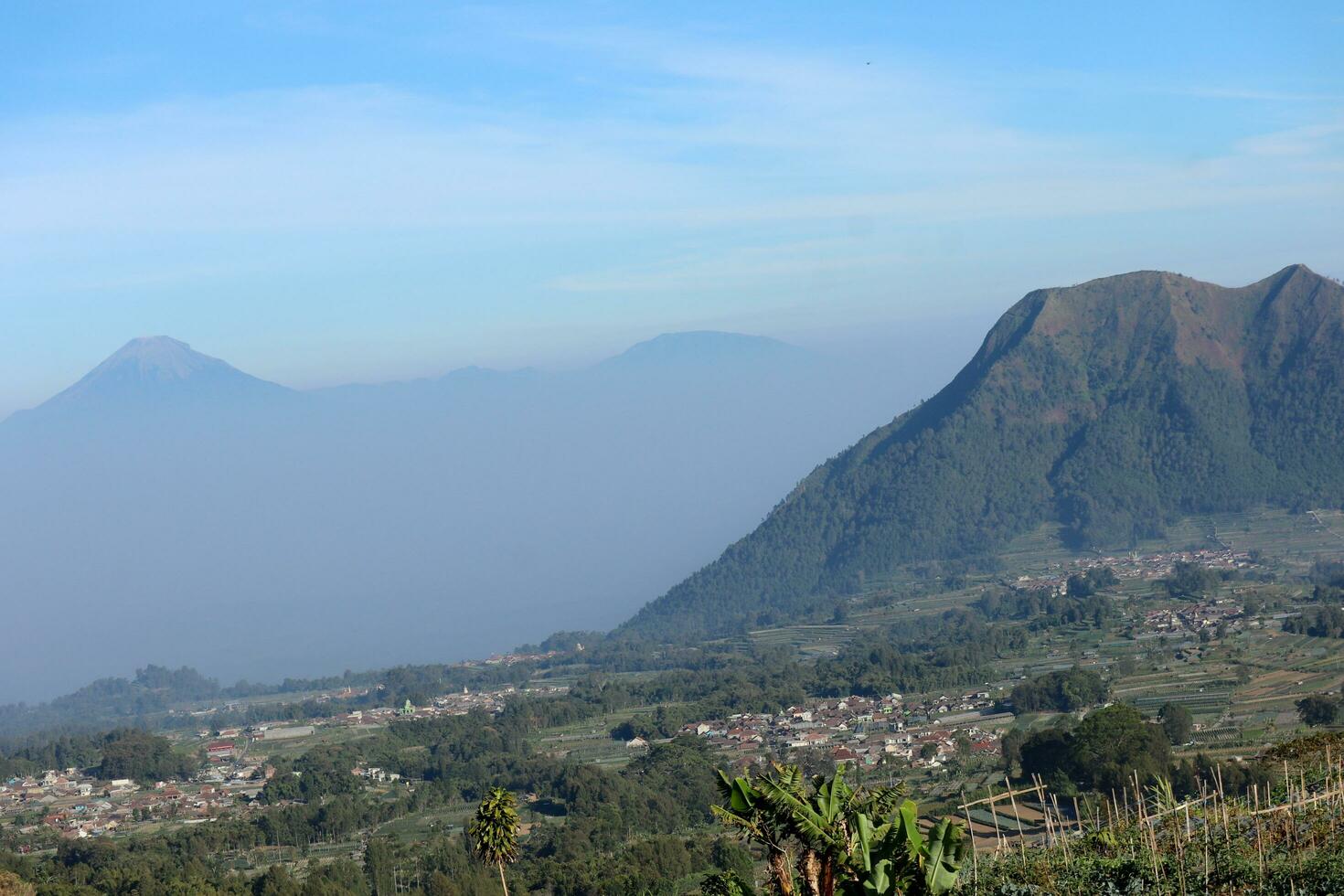 view of the peaks of several mountains at sunrise in the morning photo