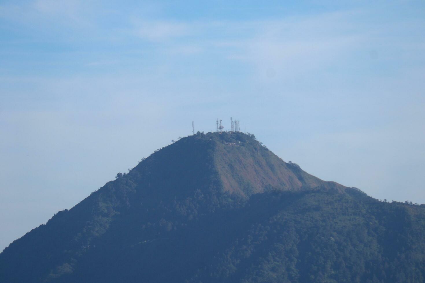 view of the peaks of several mountains at sunrise in the morning photo