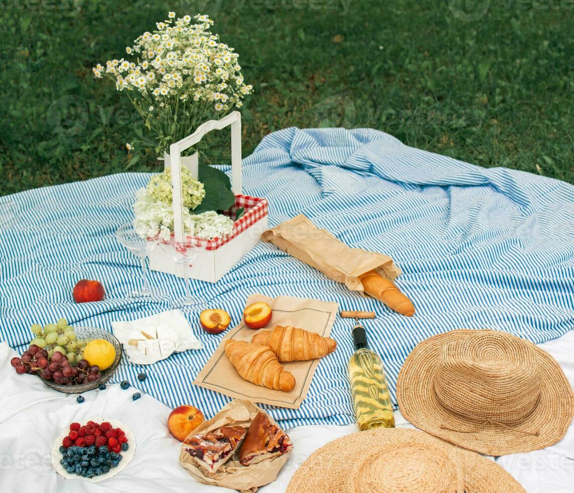 Picnic on the grass. Picnic in the park with a basket of food. photo