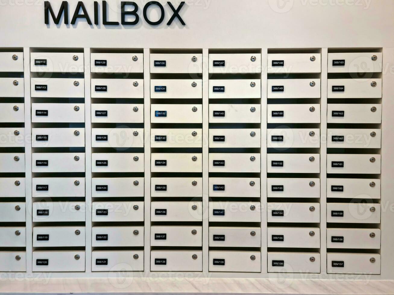 Mailbox or post office full of numbers in an apartment building photo