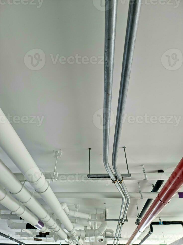 Pipes under the building for drainage systems and electrical pipes. photo