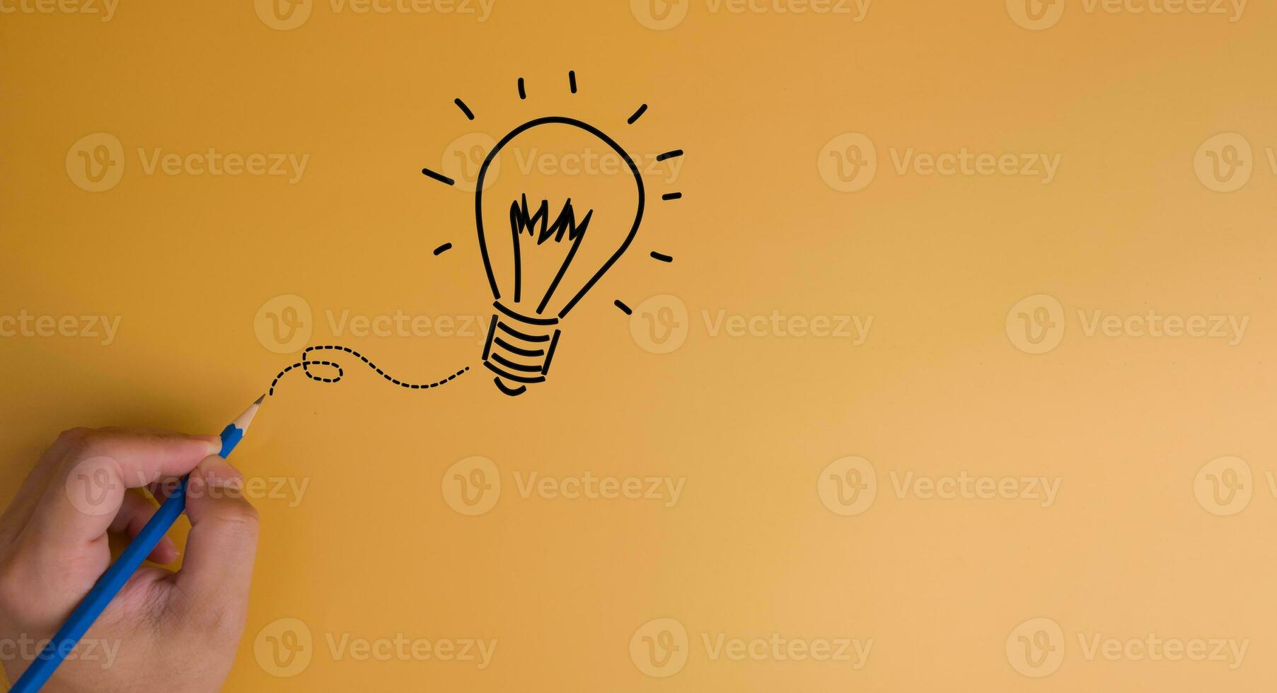 Hand pencil draw light bulb creativity innovation solution concept on yellow background.copy space photo