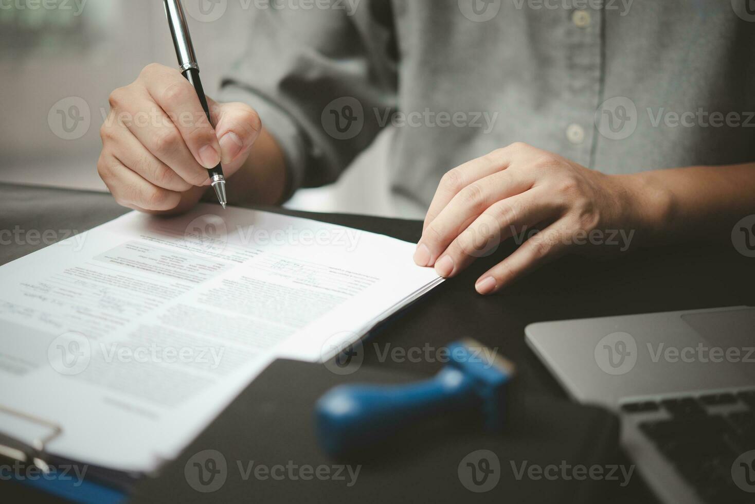 person document writing on paper with a pen, Man worker signing job contract, note, insurance and report concept. photo