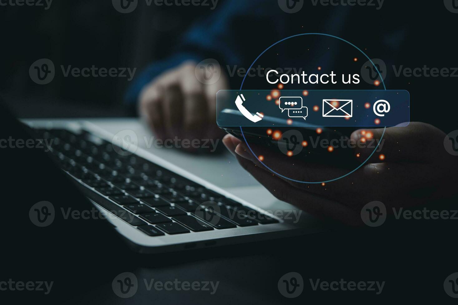 Technology communication Contact us or Customer support hotline service and online network. Businessman using mobile chat and laptop on virtual screen contact icons. photo