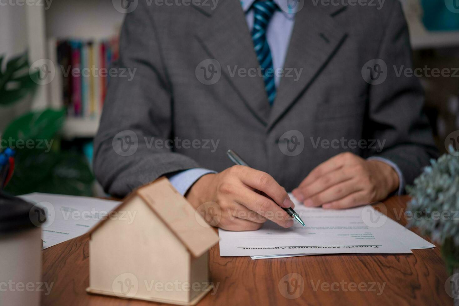 Business person Writing contract law and paper work for business and finance, write document, complete job application forms, contract real estate and insurance concept. photo