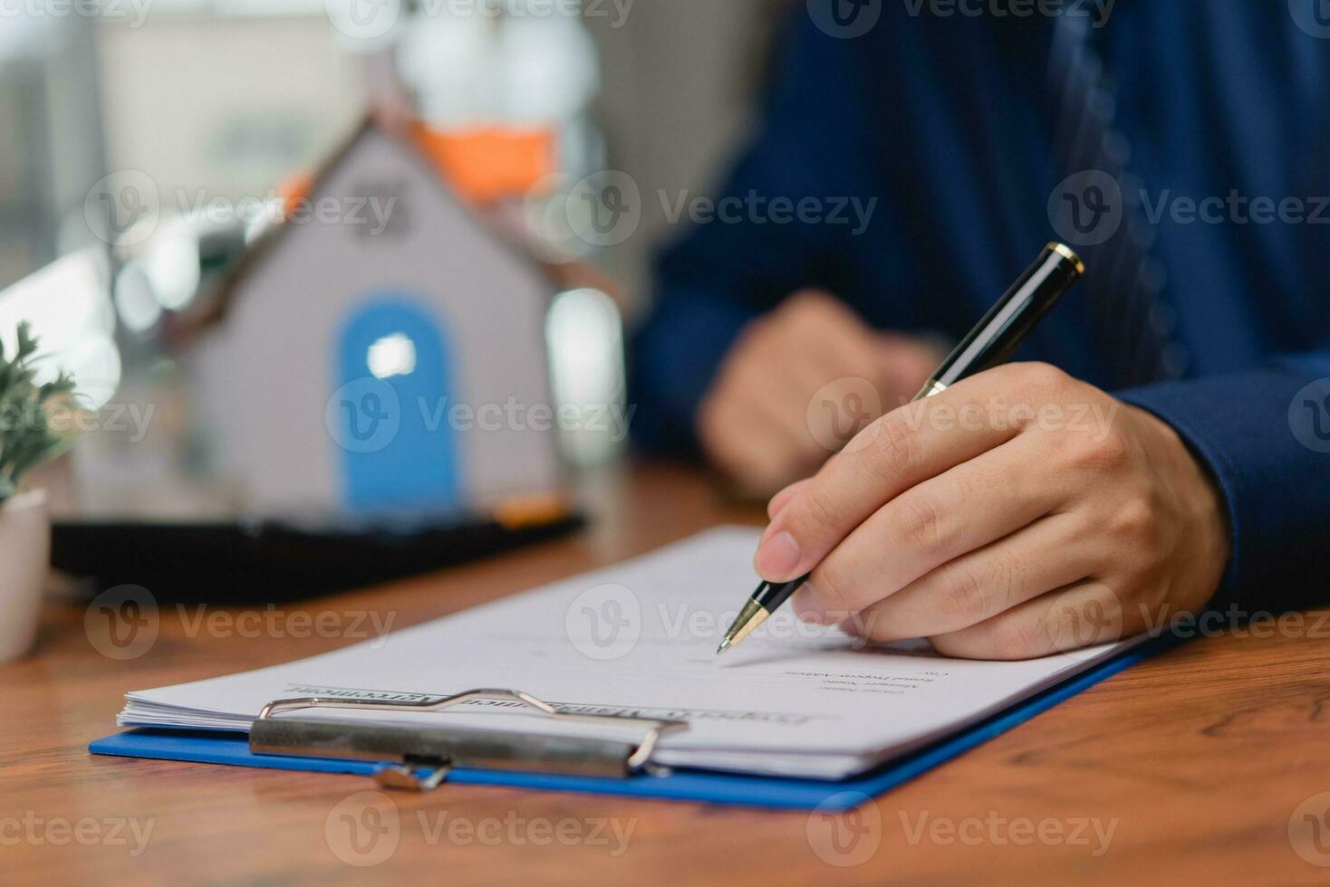 Business person Writing contract law and paper work for business and finance, write document, complete job application forms, contract real estate and insurance concept. photo