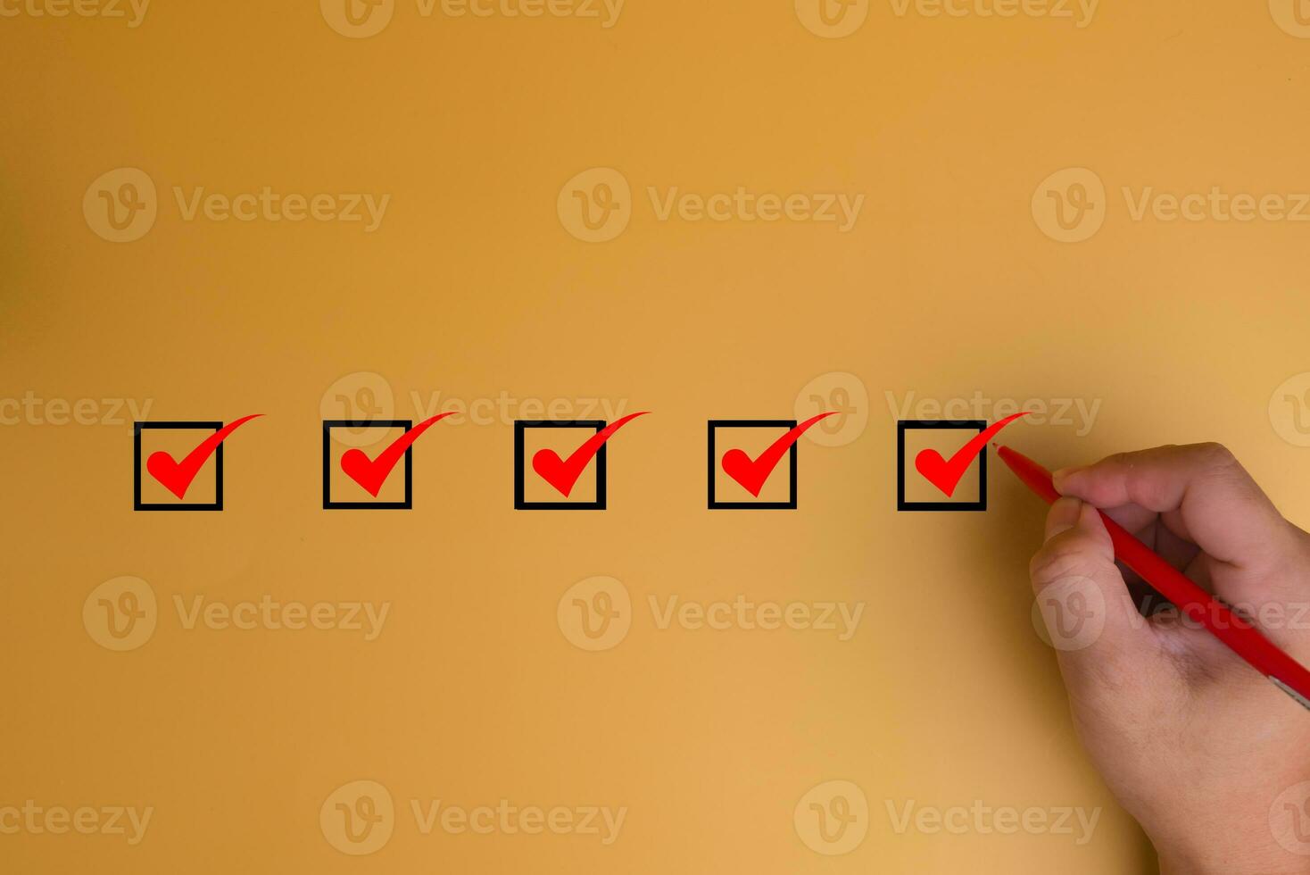 Hand using pen Checklist concept, Check mark on yellow background with copy space photo
