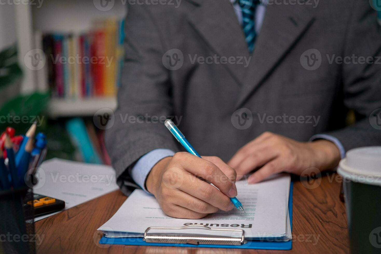 Business person Writing contract law and paper work for business and finance, write document, complete job application forms, contract real estate and insurance concept. photo
