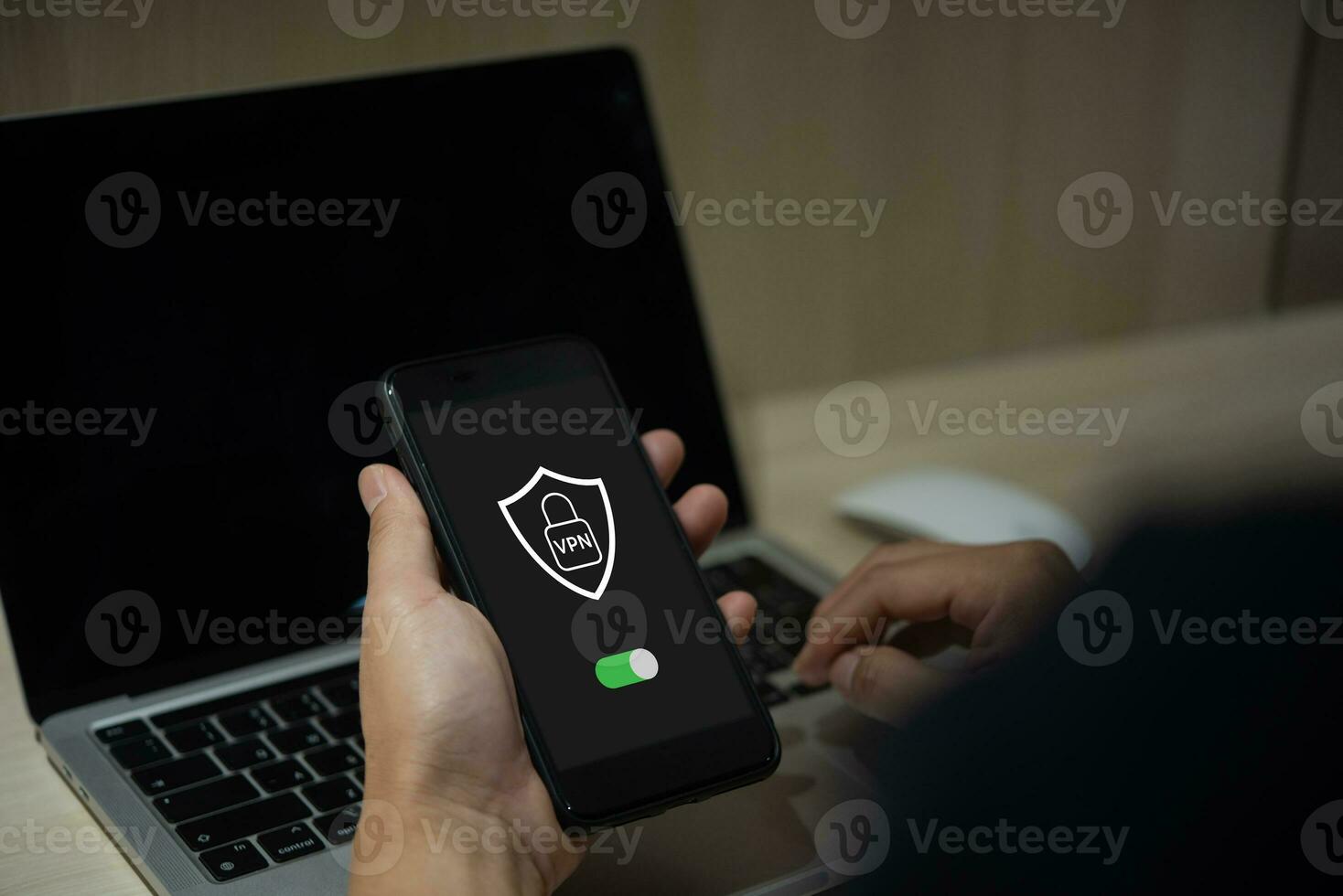 Male hand holding phone creates VPN for private network protection using Internet online. photo