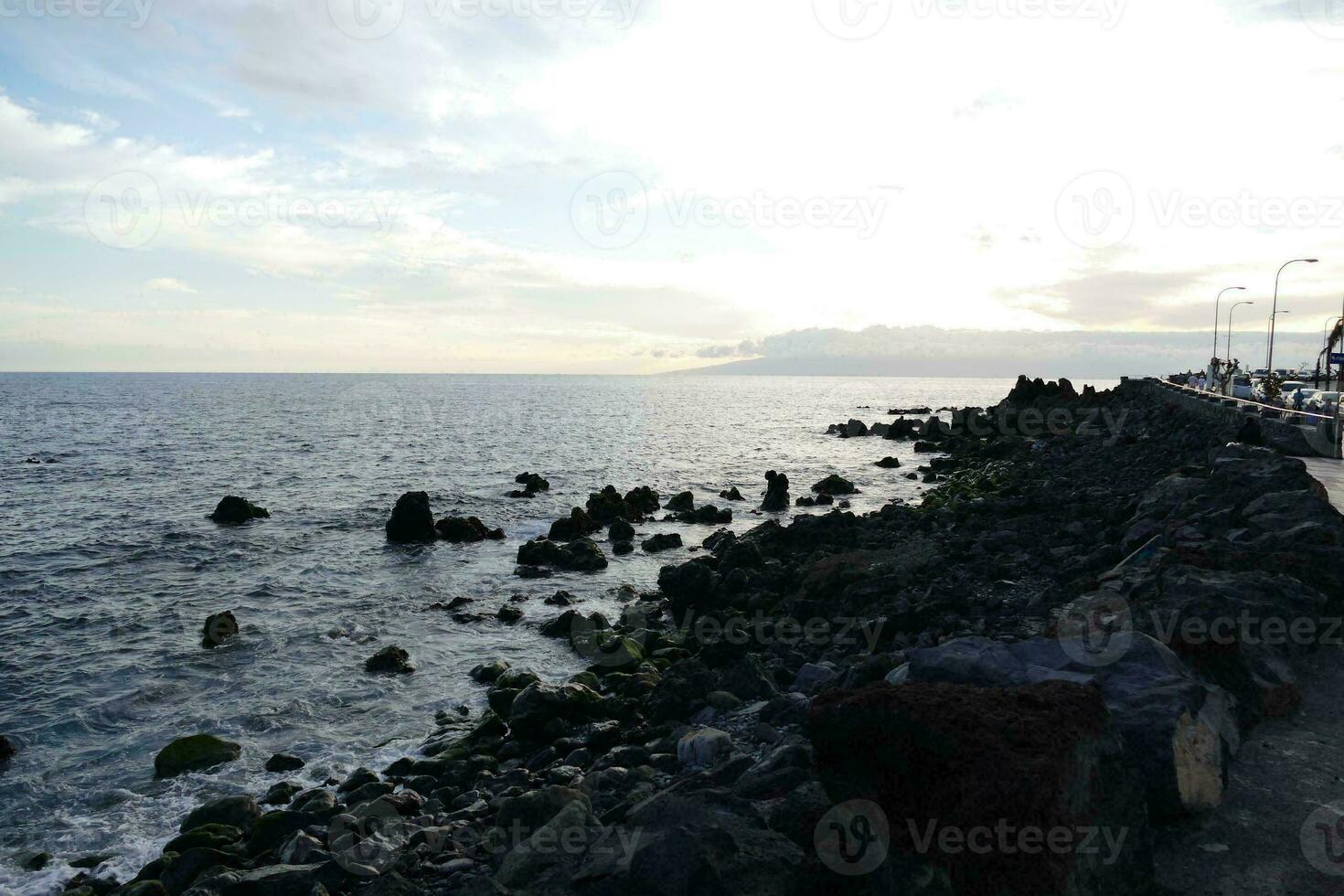 a view of the ocean from a rocky shoreline photo