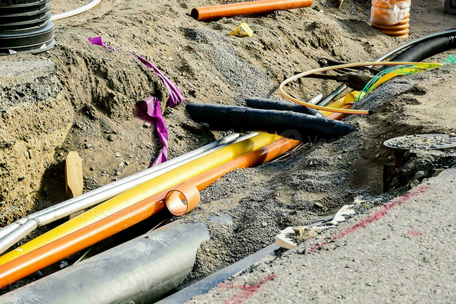 a group of wires and pipes laying on the ground photo