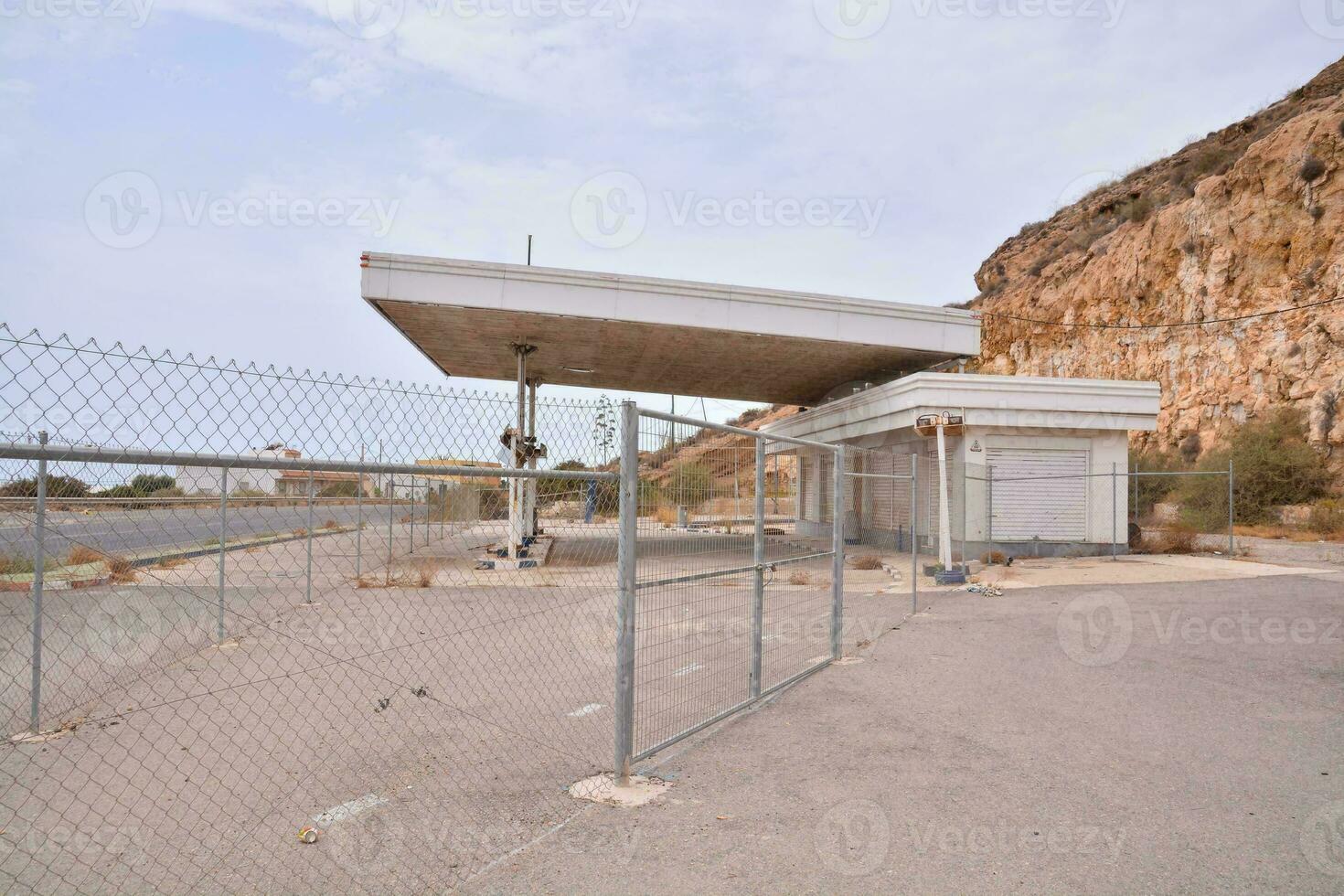 an abandoned gas station in the middle of nowhere photo