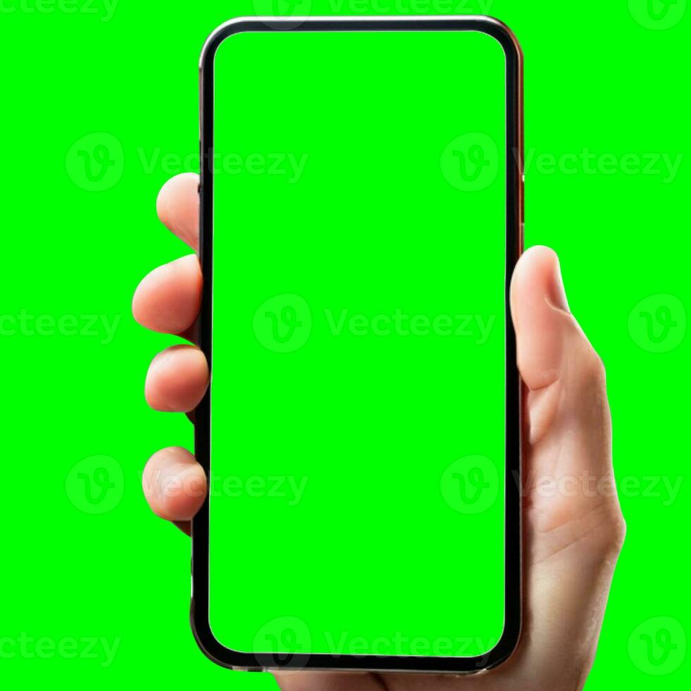 hand shows mobile smartphone with green screen in vertical position isolated on green background. Mock up mobile photo