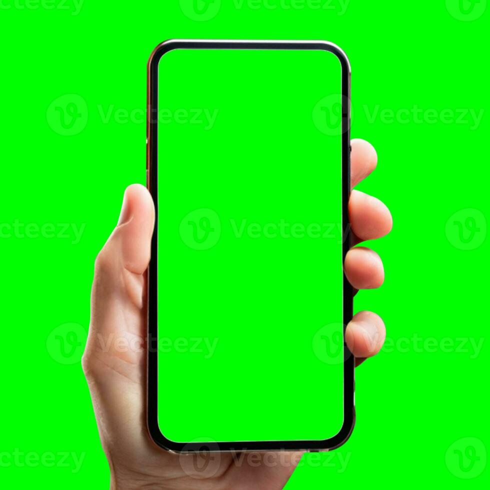 hand shows mobile smartphone with green screen in vertical position isolated on green background. Mock up mobile photo