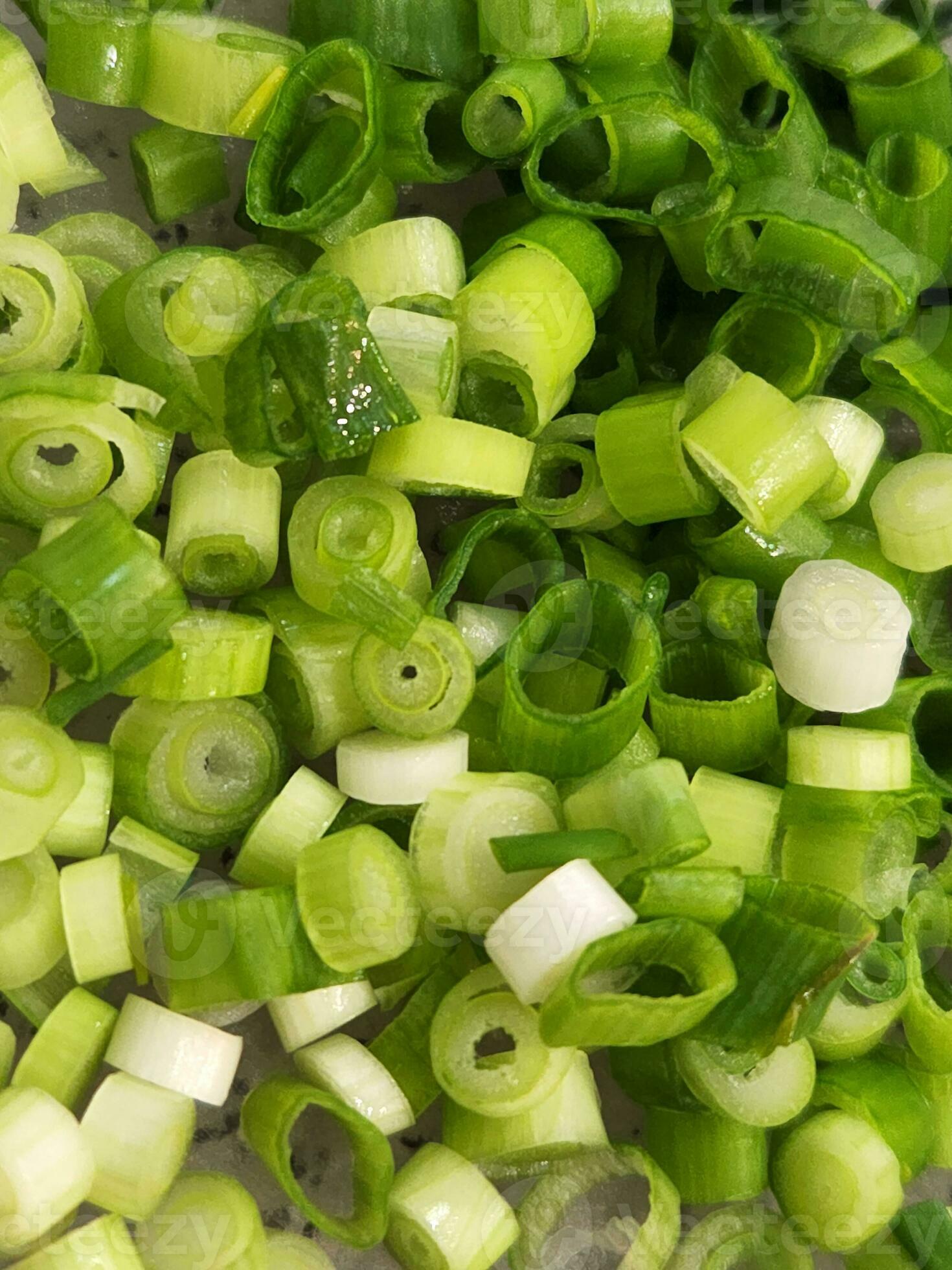 Green onions. Chopped green onions for salads. Culinary background of