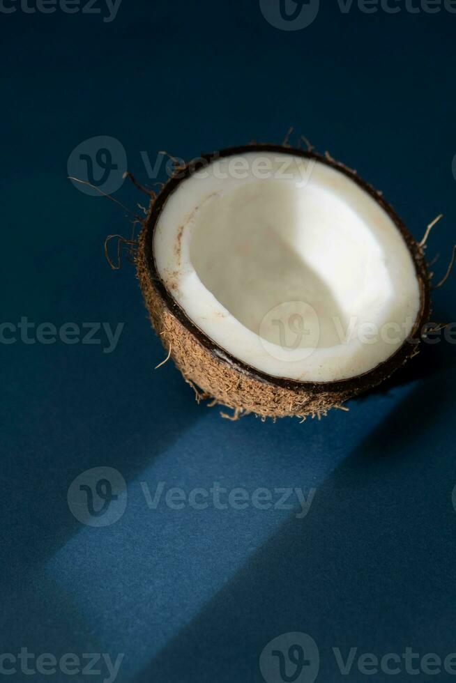 Coconut on a dark blue background, close-up photo