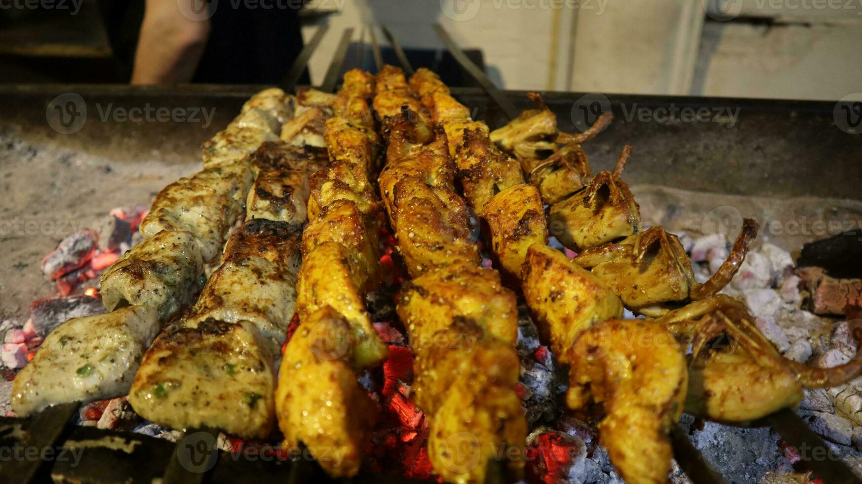 Grilled chicken shish kebab on skewers on the grill photo