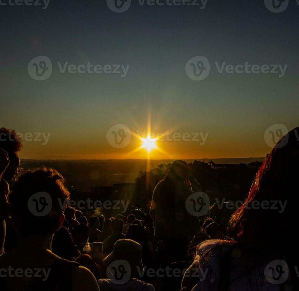 People enjoying the sunset at a music festival in the city of Lisbon, Portugal. photo
