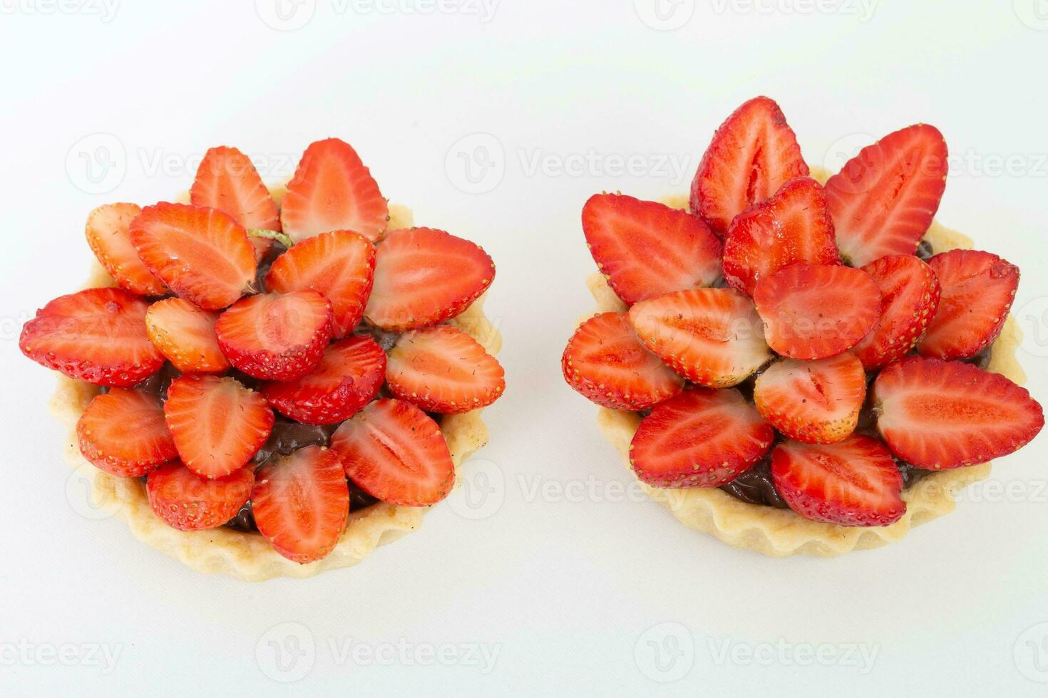 Strawberry tartlets isolated on white background, top view. photo