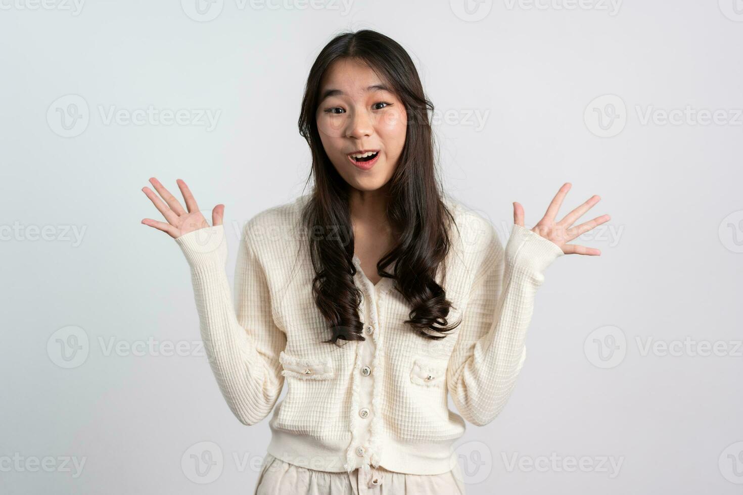Happy cheerful young Asian girl with long light hair smiling brightly feeling happy with a positive expression, joyful surprise funky, Female in black with a big smile isolated on white background. photo