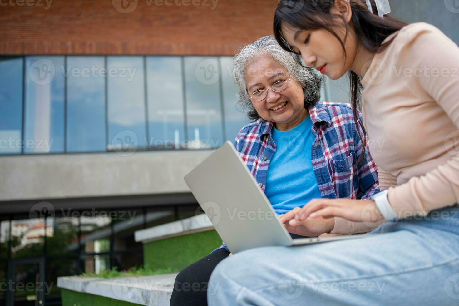 Focused young students listening old senior aged teachers for advise capstone project in university. Happy middle aged teacher working together with students for graduation project. photo