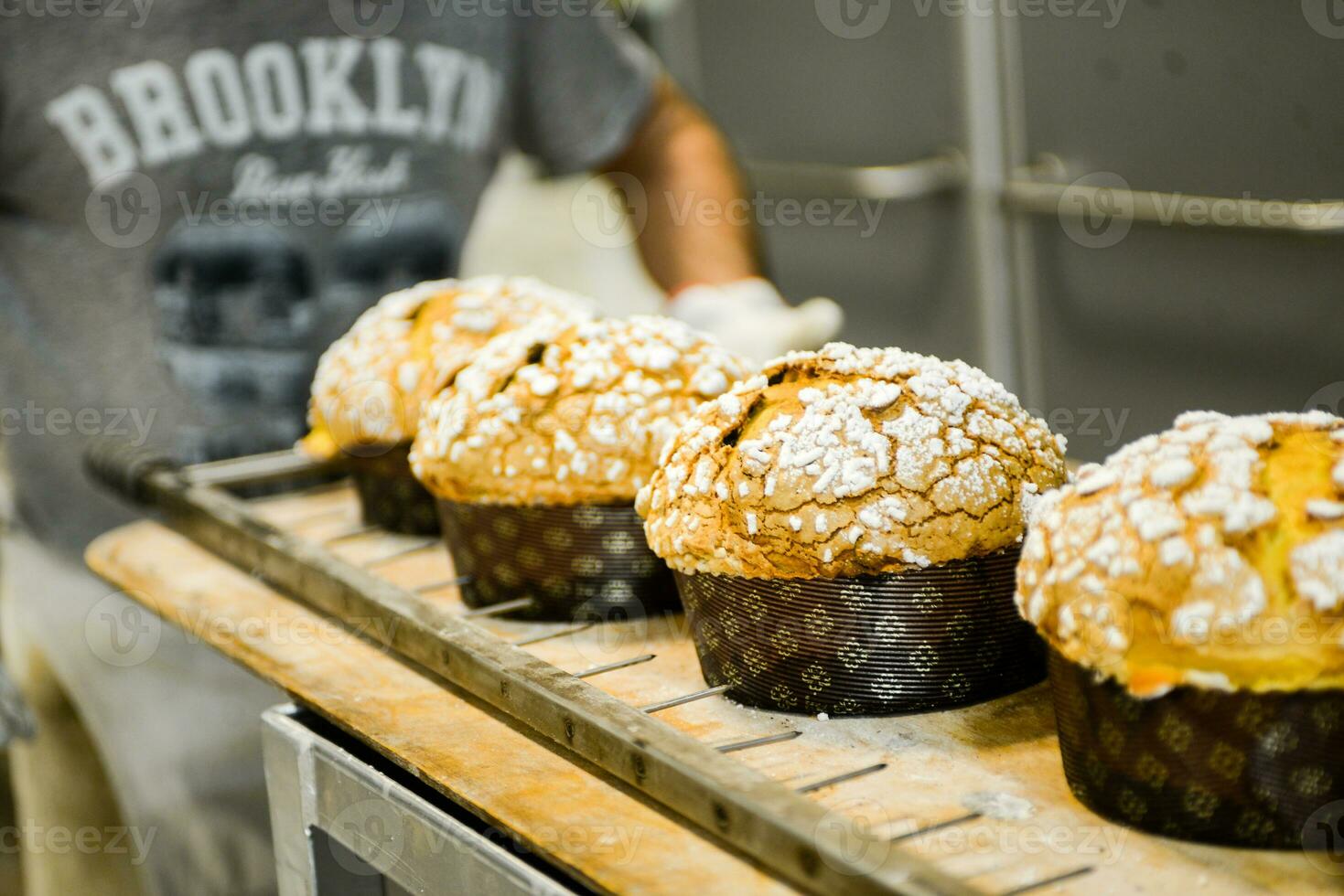 pastry baker artisan baking small group of italian panettone sweet bread typical for christmas time photo