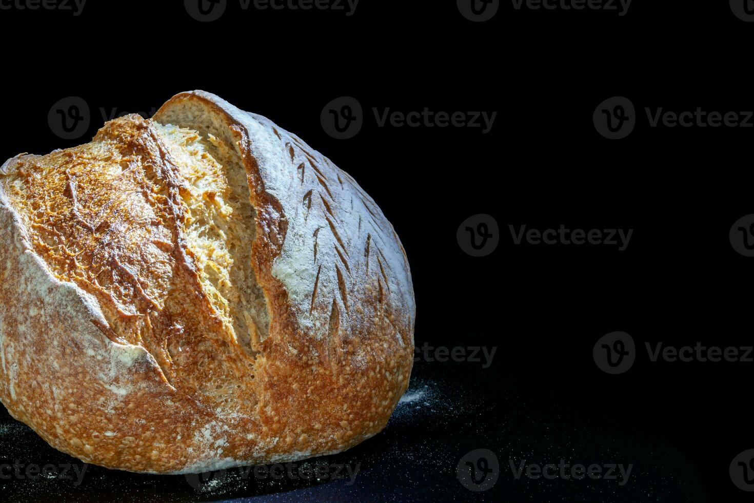 Vermont black flour rye bread with a crisp crust and porous texture. Freshly baked homemade bread. A somber moody. For text. High quality photography. photo