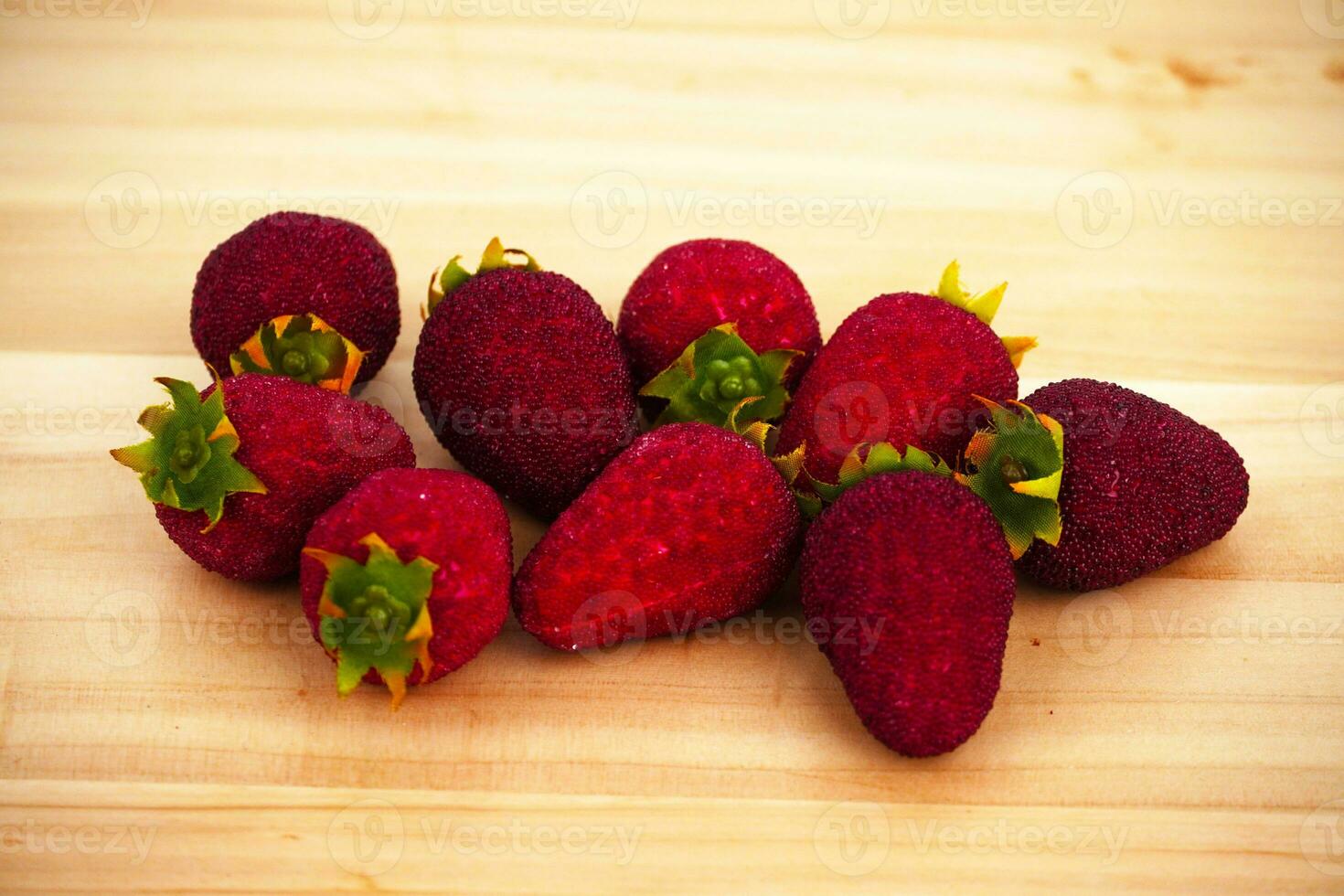 Strawberries isolated on wooden table photo