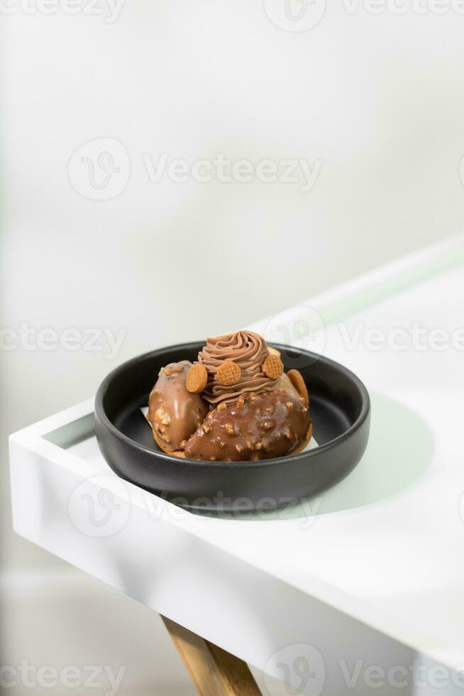 Chocolate-flavored cake mixed with almond,  with chocolate-flavored whipped cream and cookies on top. photo