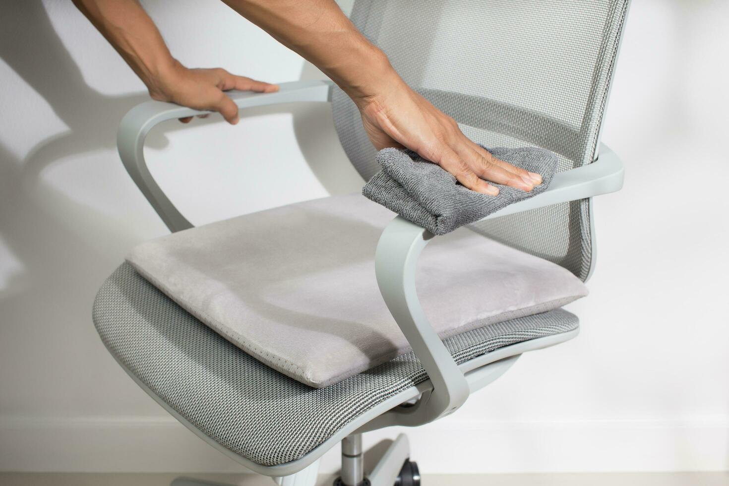 A man clean chair armrest. photo