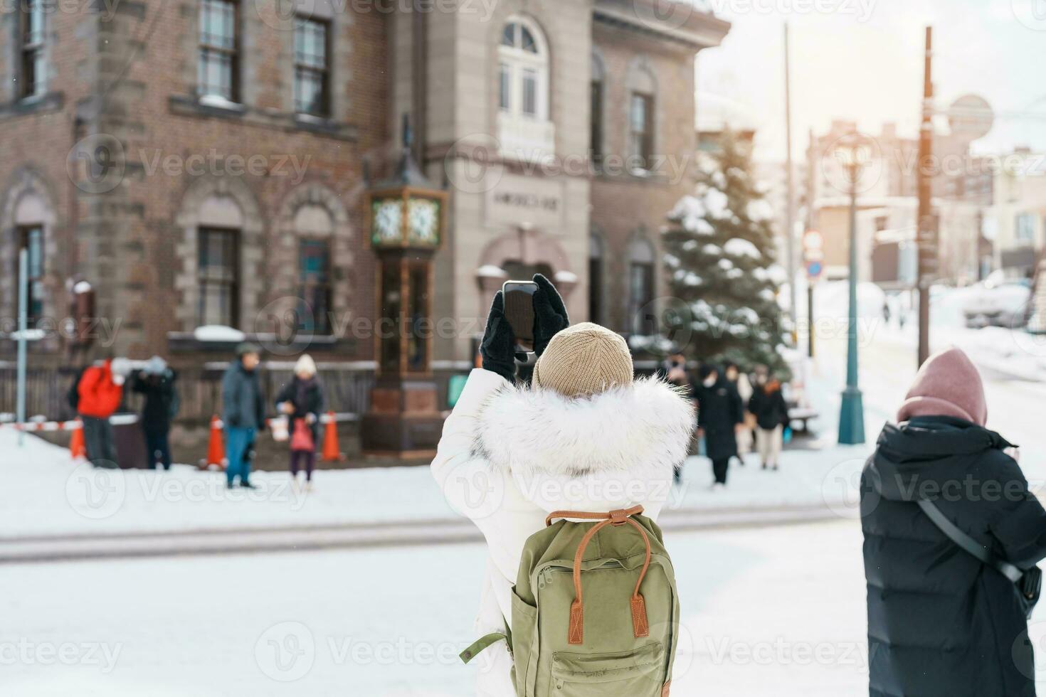 Woman tourist Visiting in Otaru, Traveler in Sweater sightseeing Otaru Music Box Museum with Snow in winter season. landmark and popular for attractions in Hokkaido, Japan. Travel and Vacation concept photo