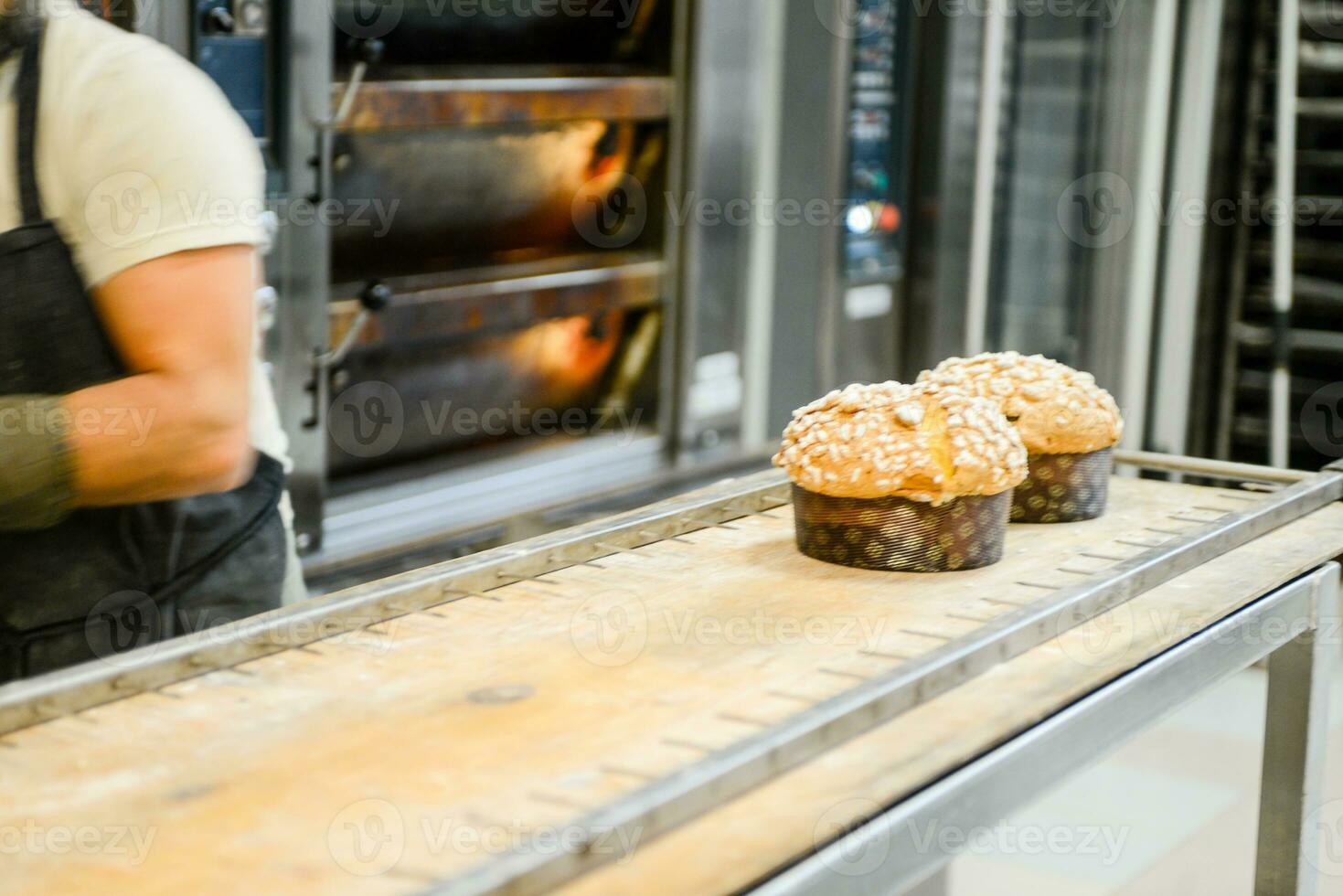 pastry baker artisan baking small group of italian panettone sweet bread typical for christmas time photo