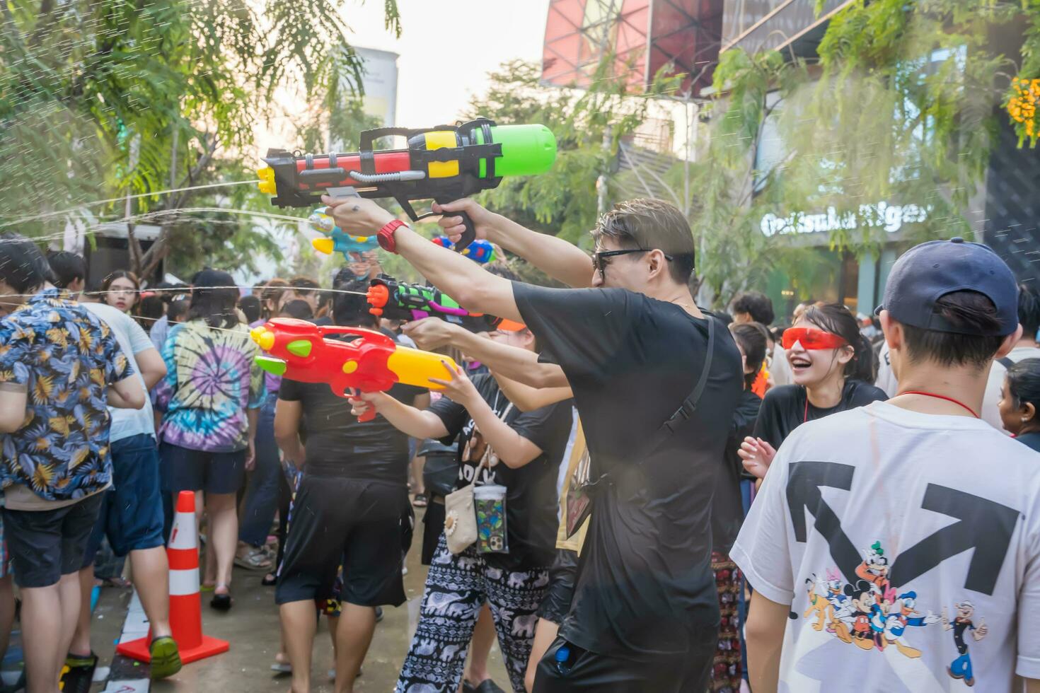 Siam Square, Bangkok, Thailand - APR 14, 2023 Songkran Festival, The short action of people joins celebrations of the Thai New Year or Songkran in Siam Square Bangkok, Thailand. photo