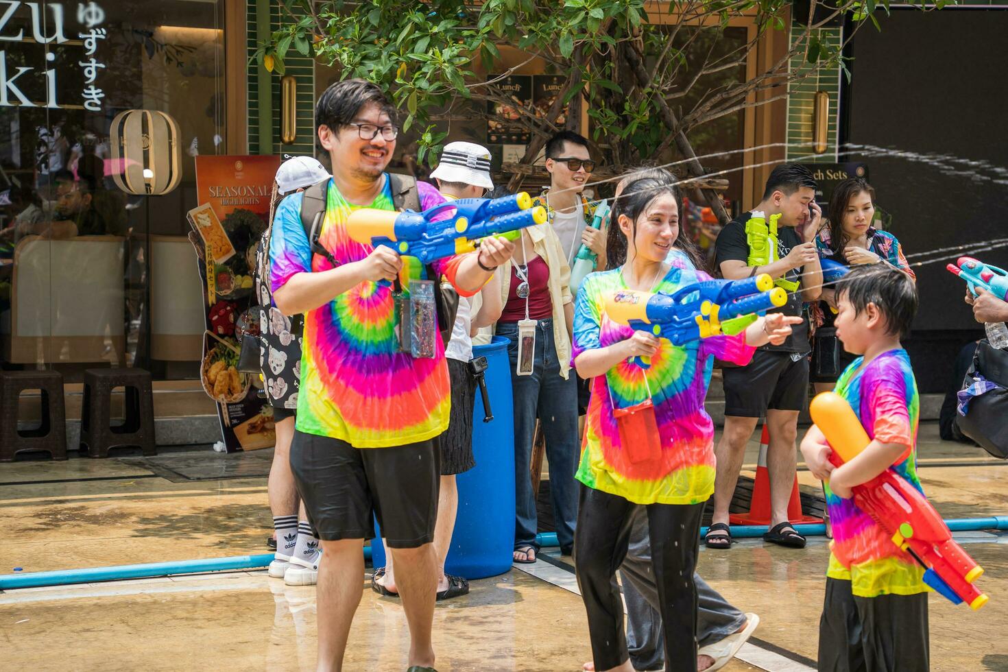 Siam Square, Bangkok, Thailand - APR 14, 2023 Songkran Festival, The short action of people joins celebrations of the Thai New Year or Songkran in Siam Square Bangkok, Thailand. photo