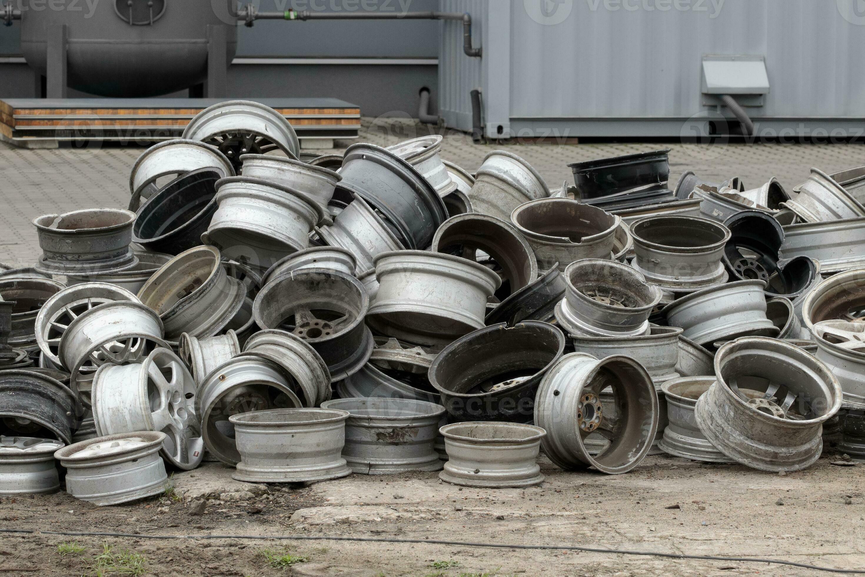 Old Car Rims Pile at Scrapheap Junkyard. Stack of old discarded wheels