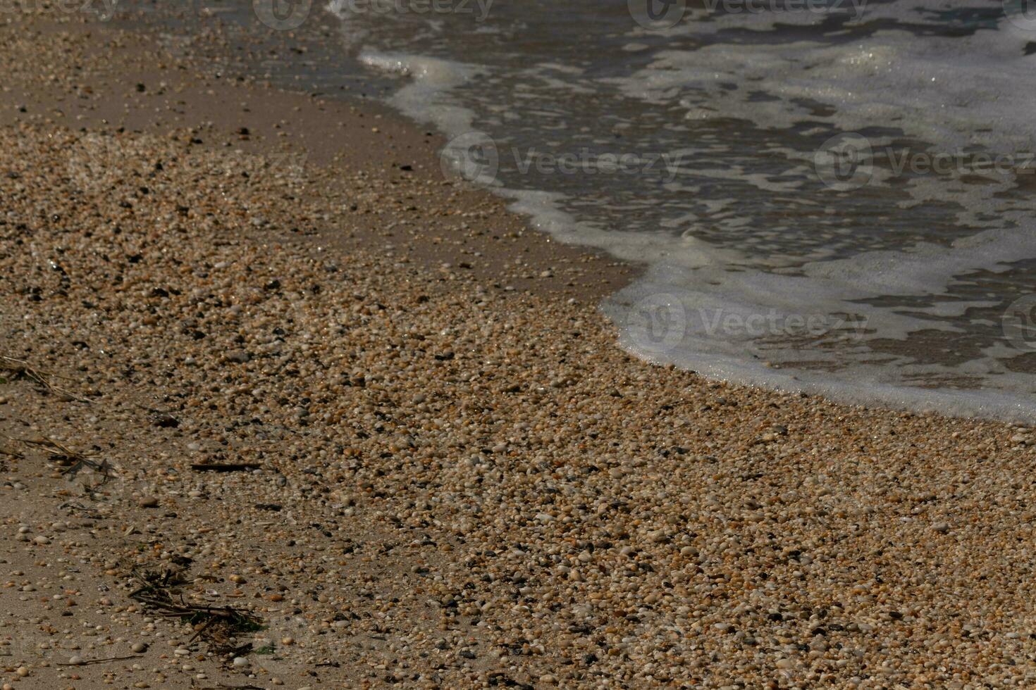 I loved the look of the ocean coming into the beach here. The sea foam slowly washing over the pretty pebbles some of which look like gems and are translucent all very smooth from being tumbled. photo