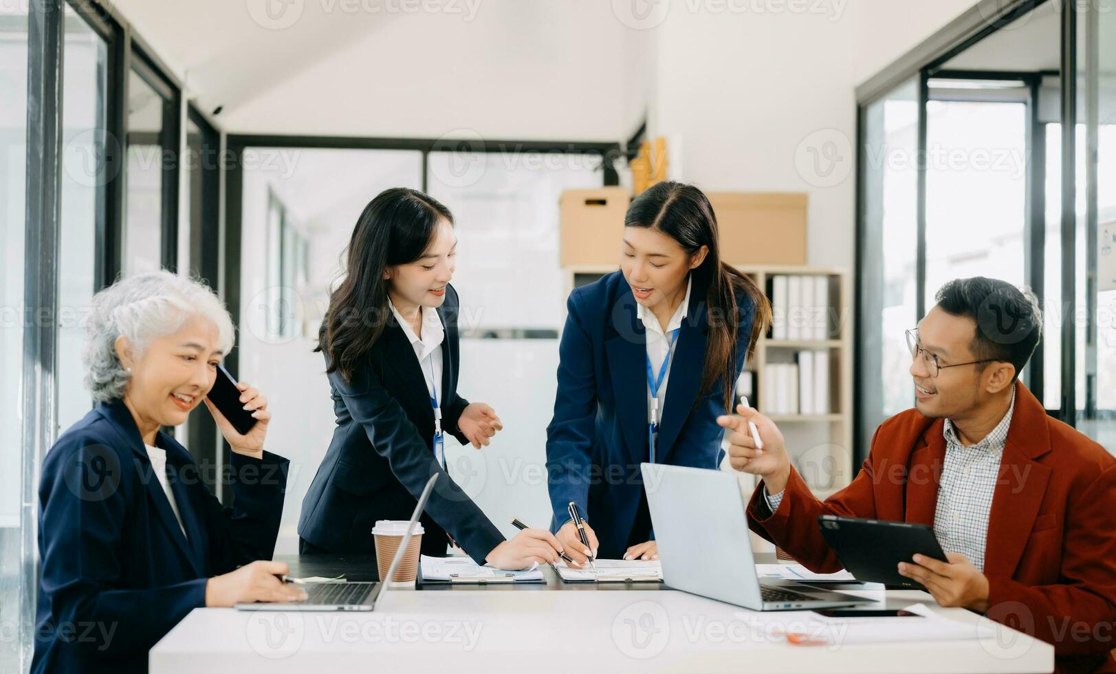Business team discuss at meeting room. working together with laptop ,tablet and smart phone on desk Financial accountant , planner , meeting , introduction concept. photo