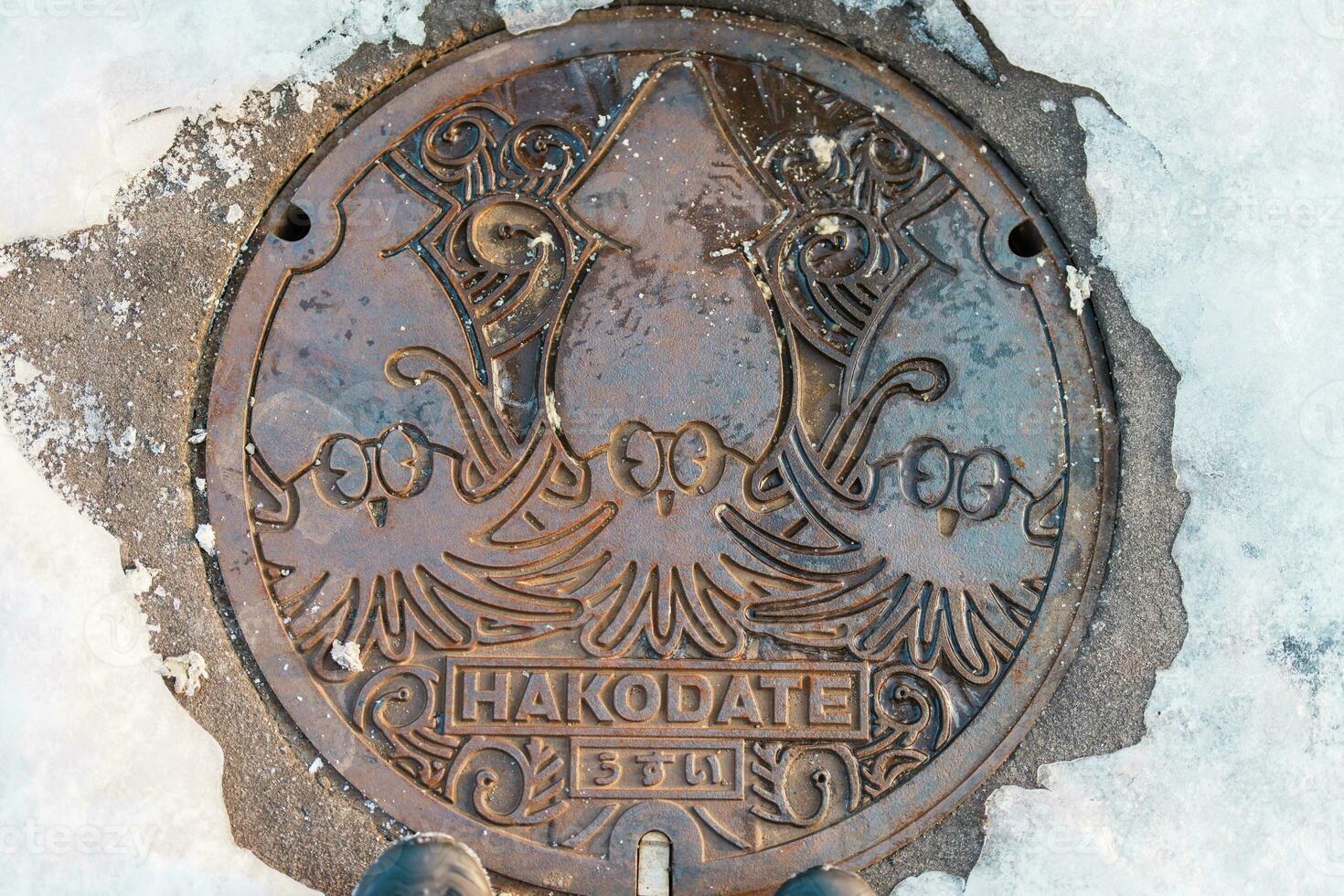 Hakodate city manhole cover with snow in winter season. Hakodate in one of landmark and popular for tourists attractions in Hokkaido, Japan. Travel and Vacation concept photo