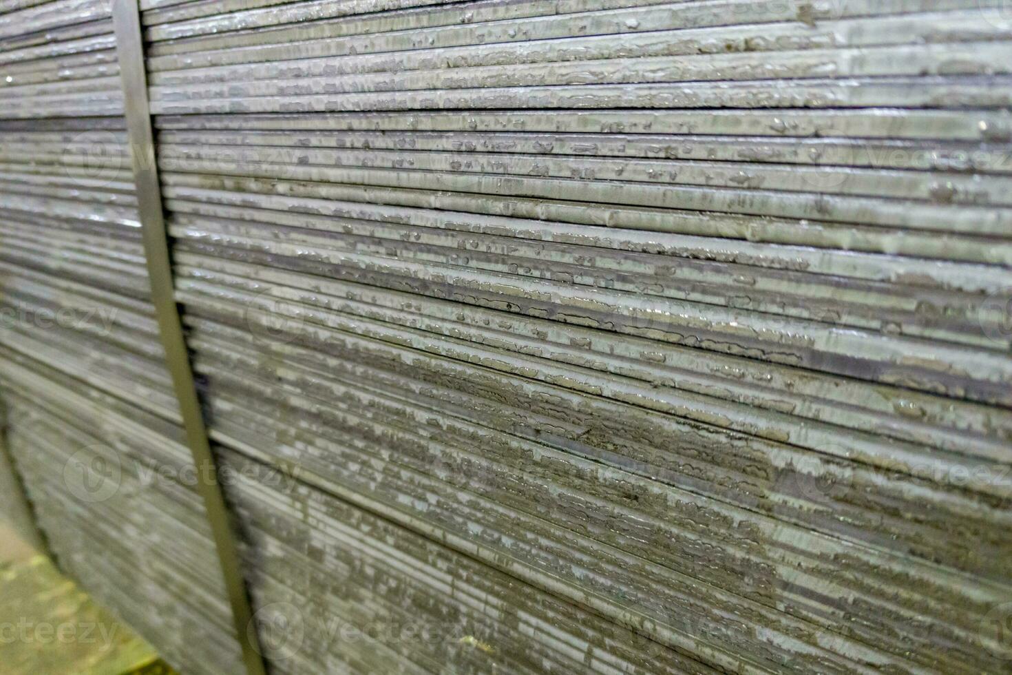 stack of mild steel sheets, full-frame close-up view with selective focus photo