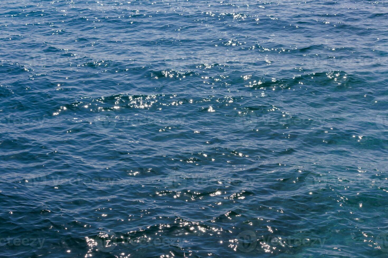 generic boundless sea water surface, only blue water at day time with mild ripple vawes photo