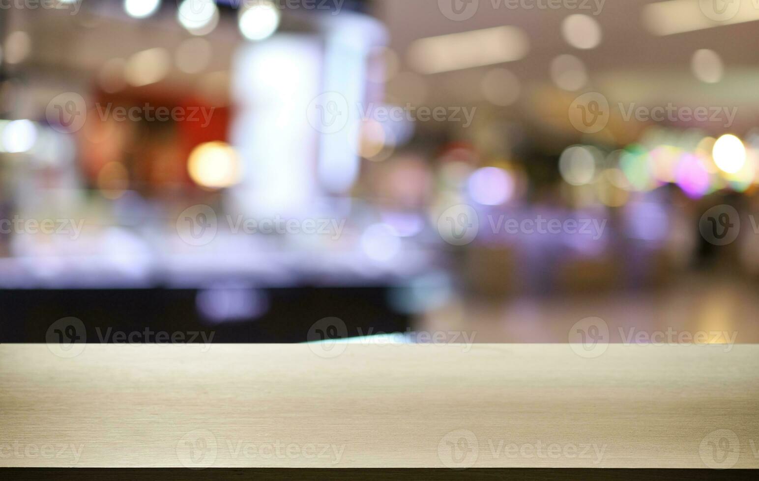 Empty wooden table in front of abstract blurred background of coffee shop . can be used for display or montage your products.Mock up for display of product photo