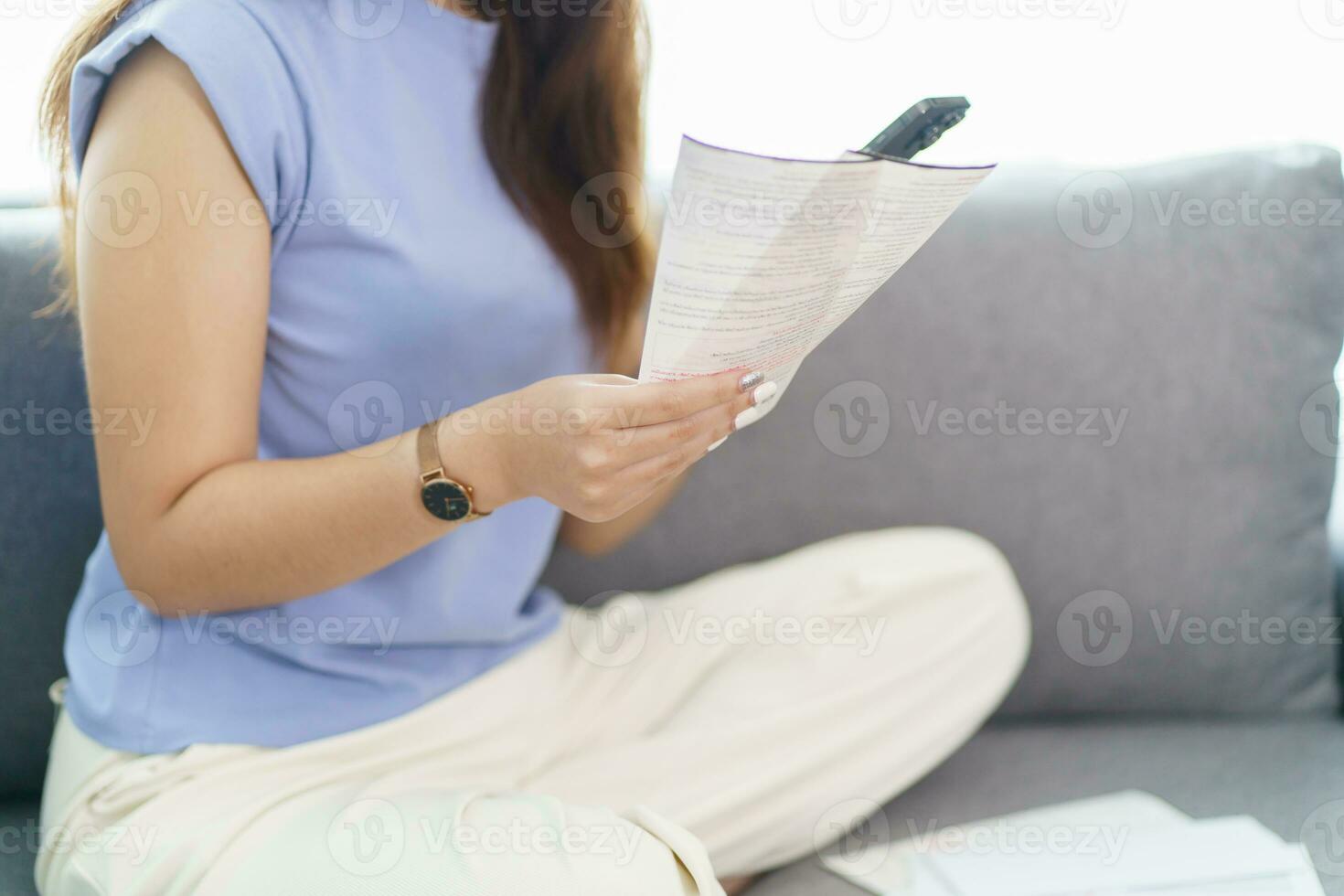 Asian woman holding paper document calculating money savings paying bills in mobile application using smart phone payment online with paying household bills tax insurance managing budget. photo