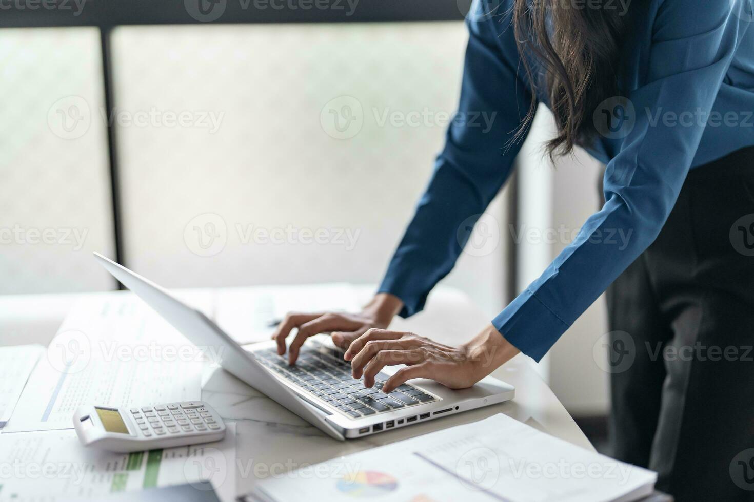 Working by using a laptop computer on wooden table. Hands typing on a keyboard.technology e-commerce concept photo